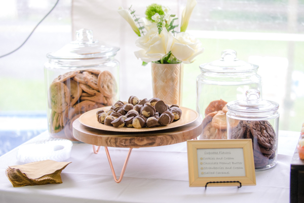 Chocolate covered cookie dough bites on a gold plate and glass clear jars of huge cookies at fawn hollow acres