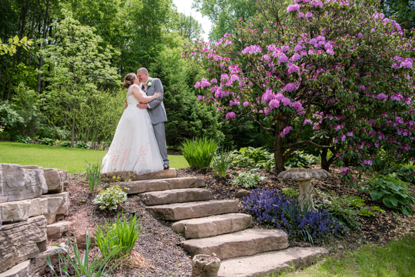 Spring wedding at Fawn Hollow Acres. Outdoor with stone steps and pink tree in full bloom
