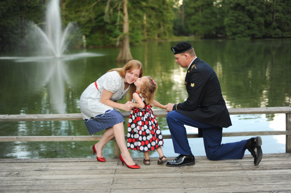 Army family with little girl kissing Mommy at Swan Lake