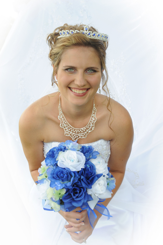 bride with tiara and royal blue flower bouquet
