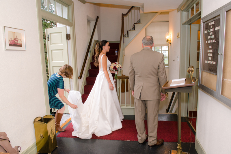 "I DO" Details Coordinator fixing bride's train as she is waiting to walk with her father down the isle.  Taken by J & D Studio, Harrisburg Photographers